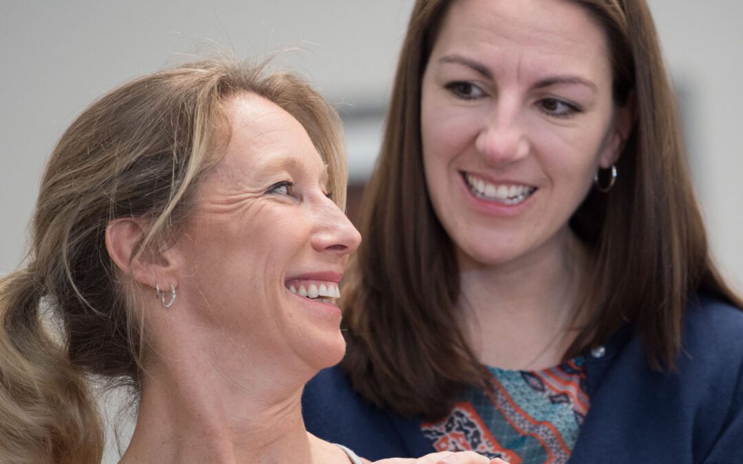 two women looking at each other and similing